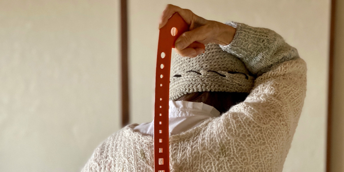 Elderly woman using backscratchers