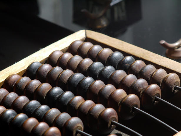 antique abacus with only one deck filled with 10 blackened beads