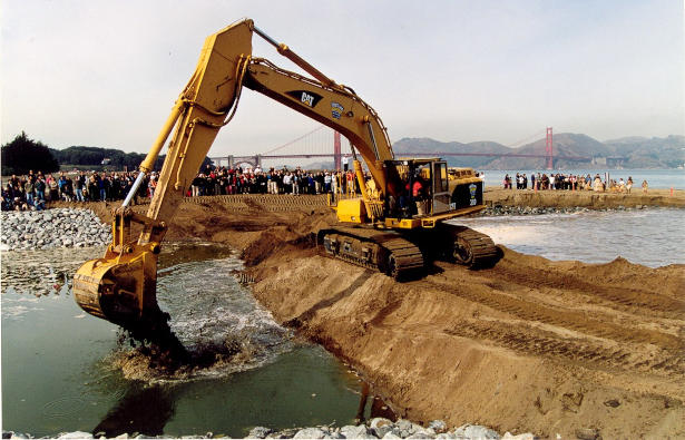 Power shovel working on a site looking like a primitive dam